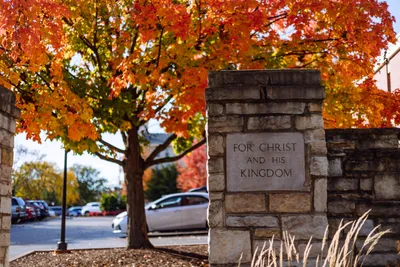 Stone Wheaton For Christ and His Kingdom Sign with Fall Tree