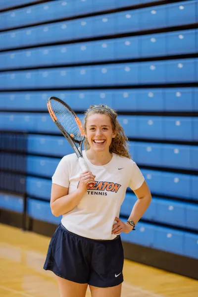 Wheaton College female tennis player with racket