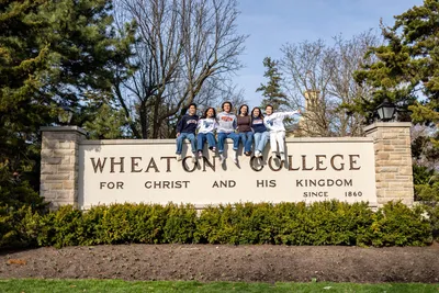 Wheaton Students on Wheaton Sign - Spring 2026