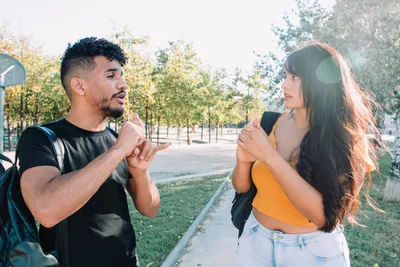 Two college students using American Sign Language