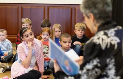 Hope Grant reads a storybook to a group of children.