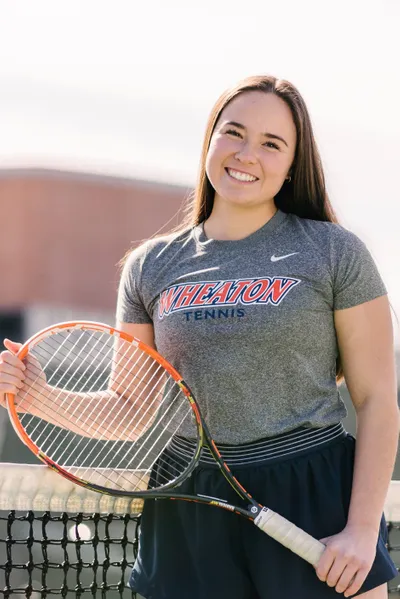 Student poses with tennis racket