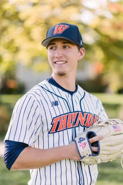 Student poses with baseball mitt