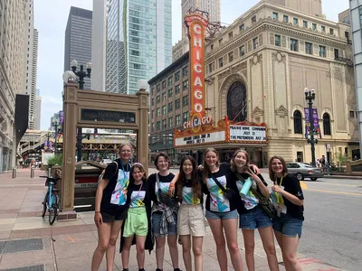 A group of students took picture at Chicago Theatre