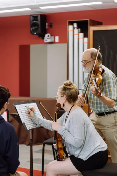 Conservatory strings professor and student in rehearsal