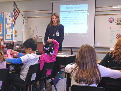 Rachel-in-classroom-with-American-flag