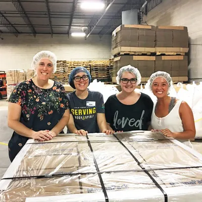 students volunteering at Feed My Starving Children
