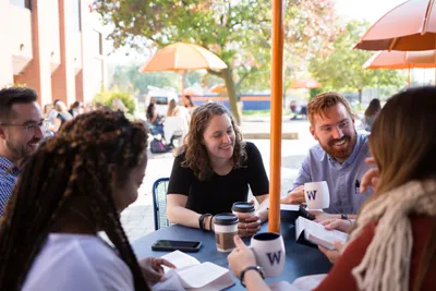 grad students sitting talking laughing banner image