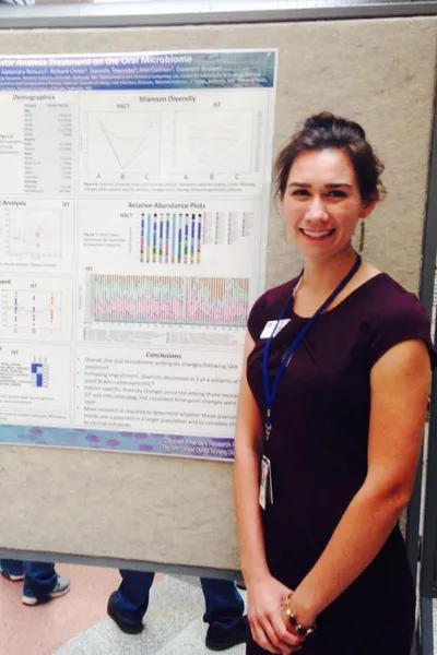 Sarah Mudra standing in front of her poster presentation