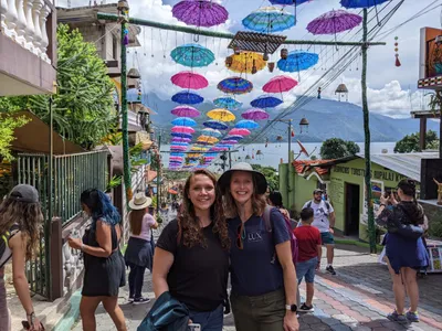HNGR Student with Dr. Amy Peeler under colorful canopy