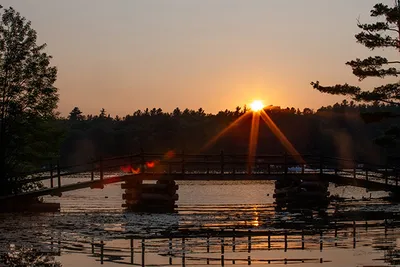 A bridge over a lake during sunset