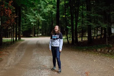 A female smiling happily on a trail