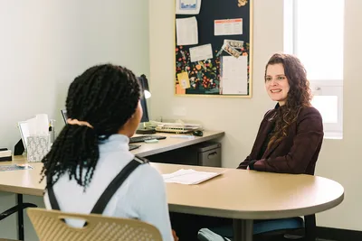 The director of LAS sitting and talking with student