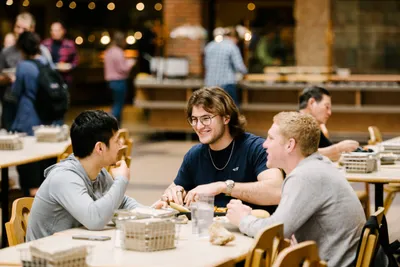 Students eating lunch at table in a dining hall