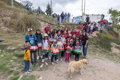 Students presenting shoe boxes filled with gifts