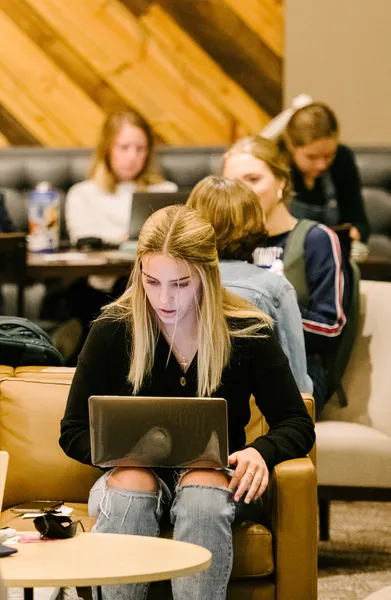 Student on laptop in common area