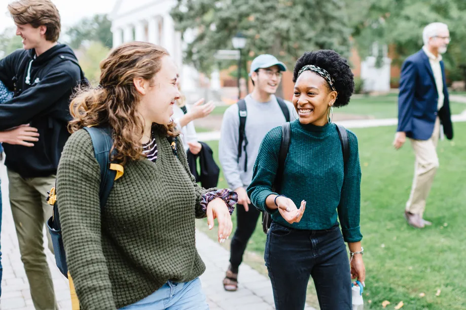 Two Undergraduate Students Walking and Talking Quad