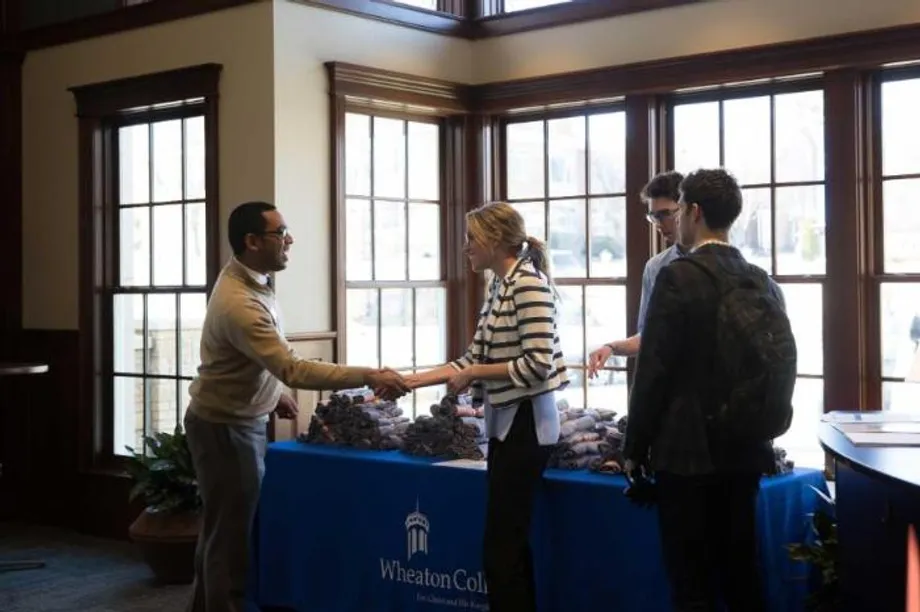 Visitors Being Welcomed to the Wheaton College IL Welcome Center