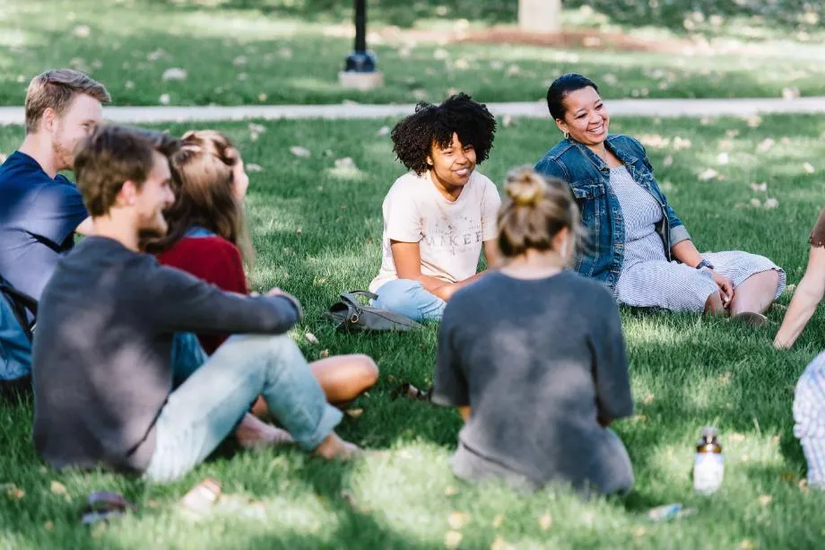 students talking on lawn