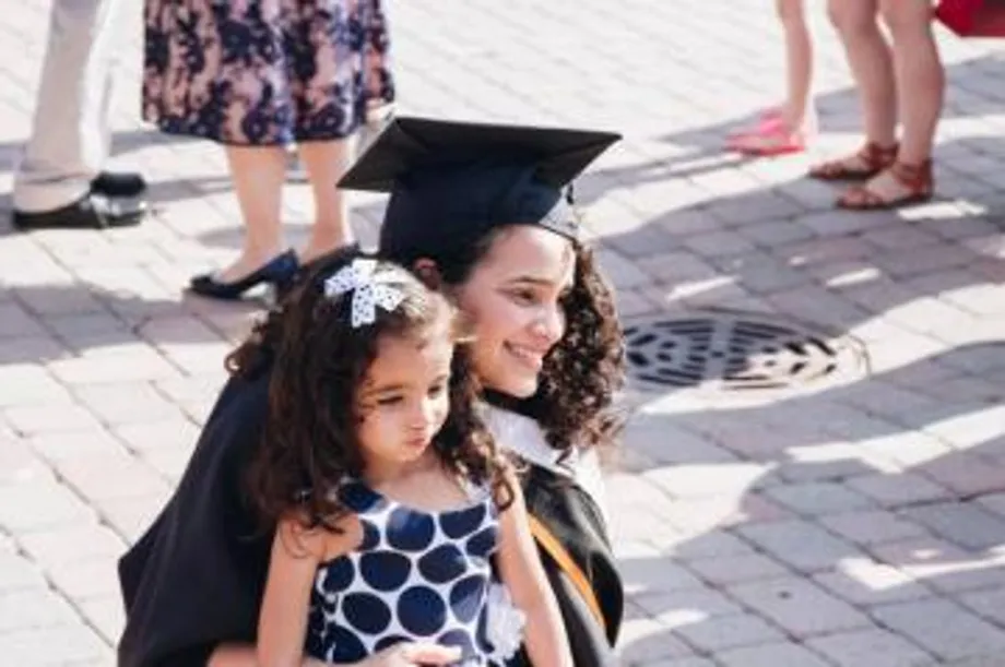 a woman and a child smiling at commencement