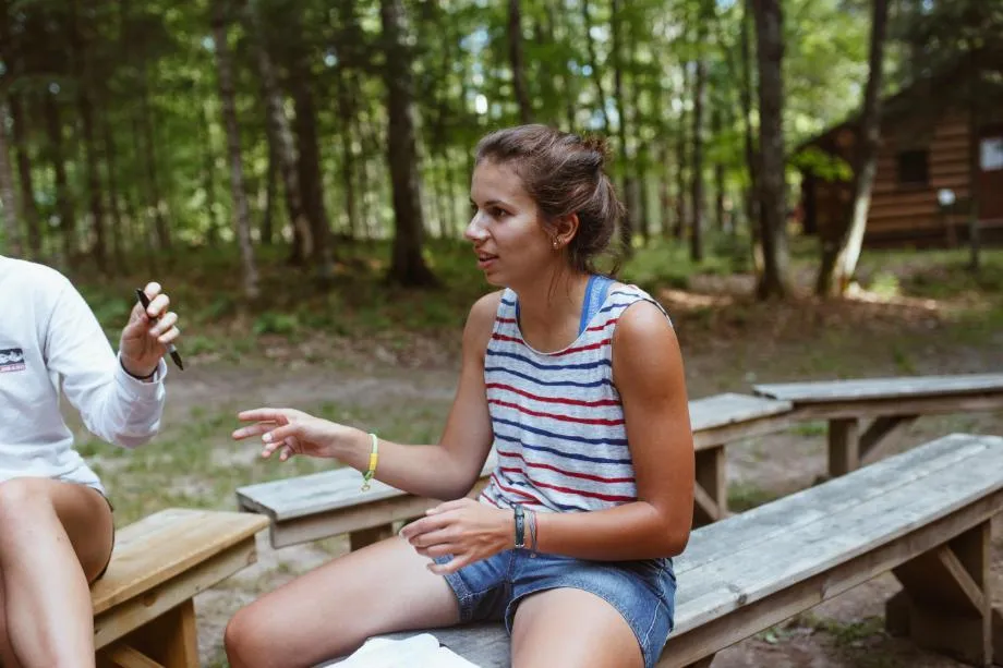 Vanguard Alaina sits and talks by the fire