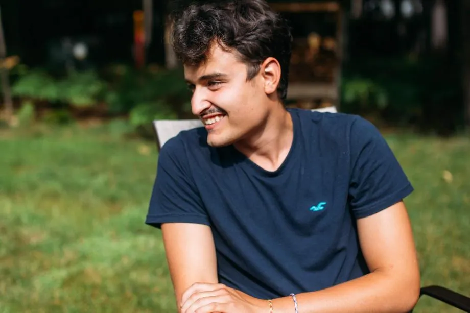 matthew sits and smiles