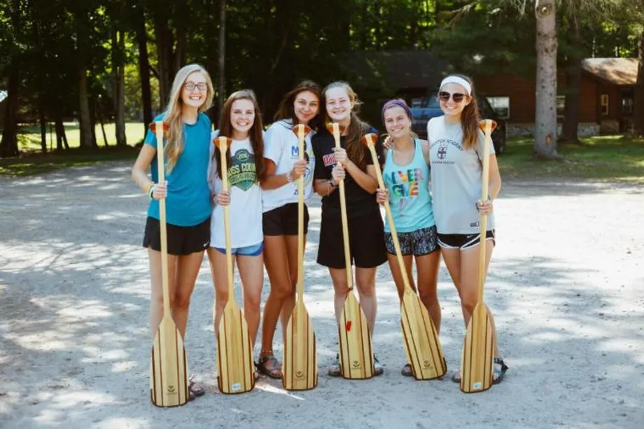 voyageur campers standing with paddles