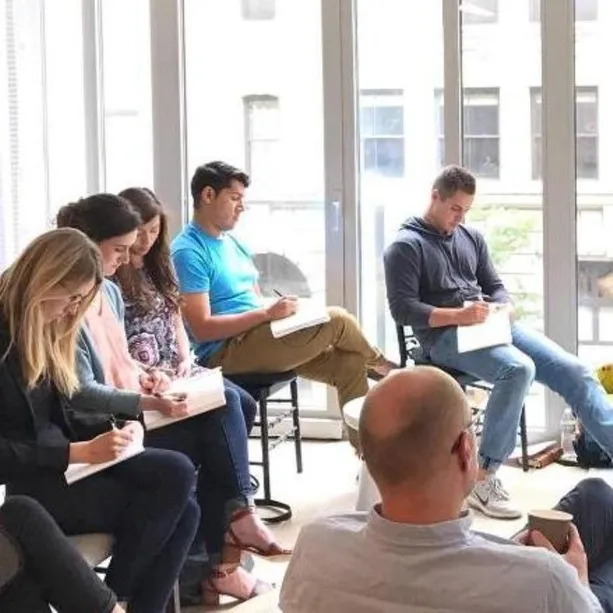 Small Group of People Listening to a Speaker