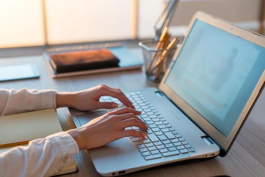 hands on a laptop