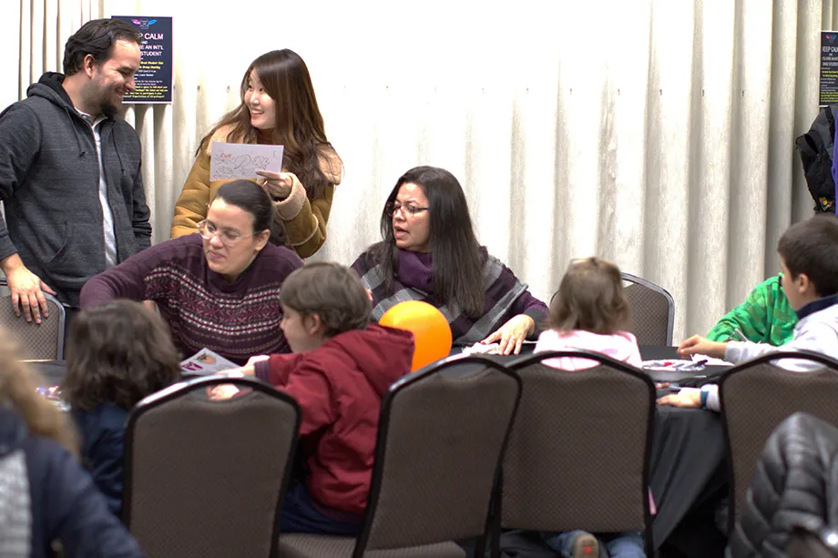 920x613 grad students with families at luncheon