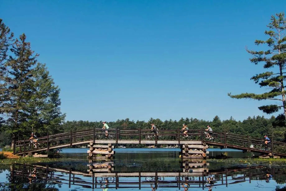 bikers ride over the bridge at honeyrock