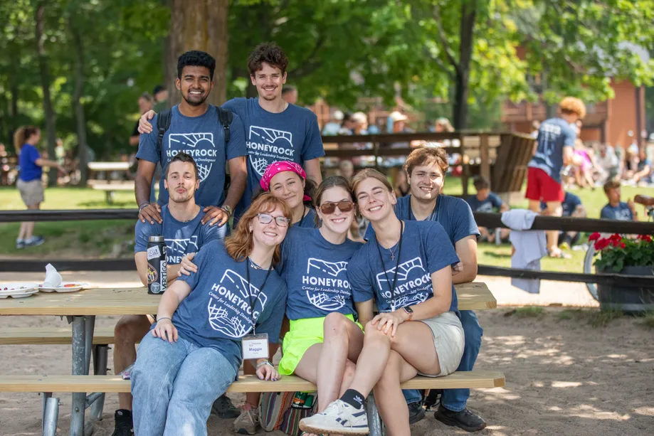 A group of students sitting outside in HoneyRock tshirts