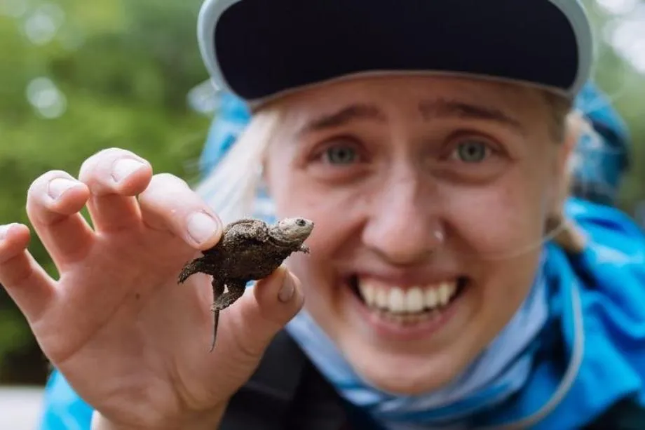 olivia cassel holds a turtle