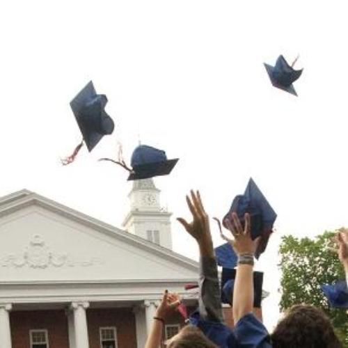 Graduating students throwing caps in the air