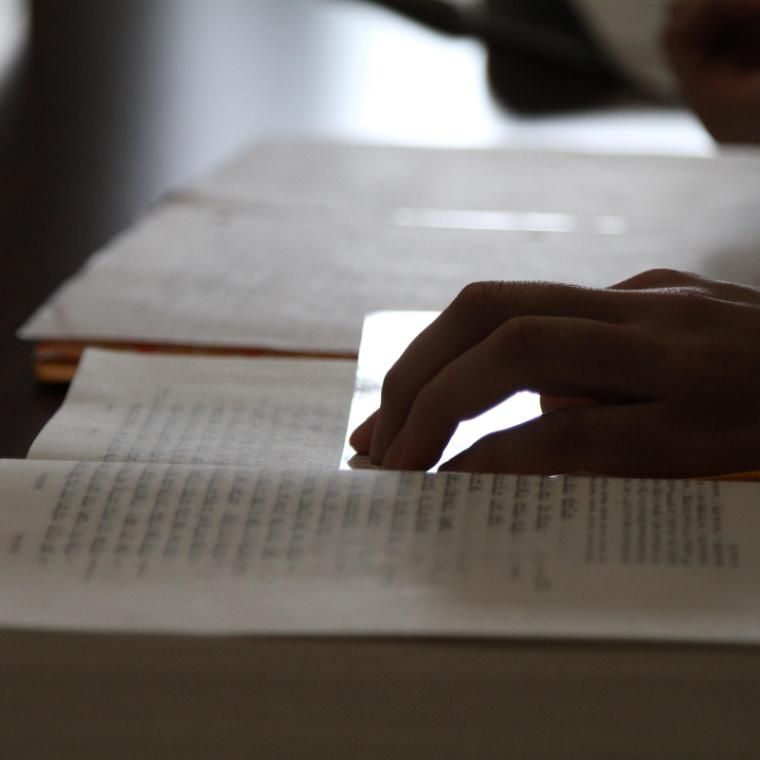 a hand on a bible