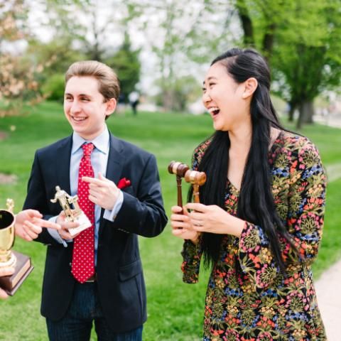 Wheaton College Debate Students holding trophies