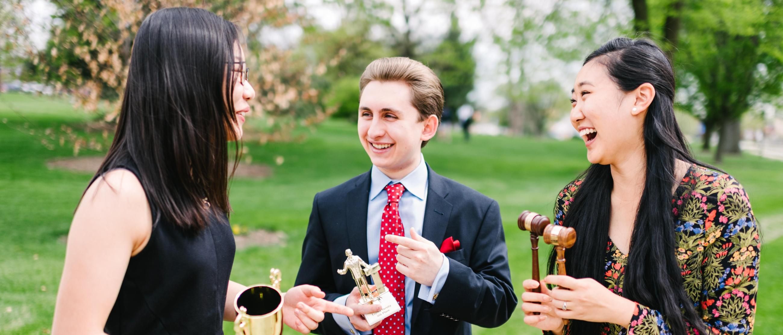 Wheaton College Debate Students holding trophies