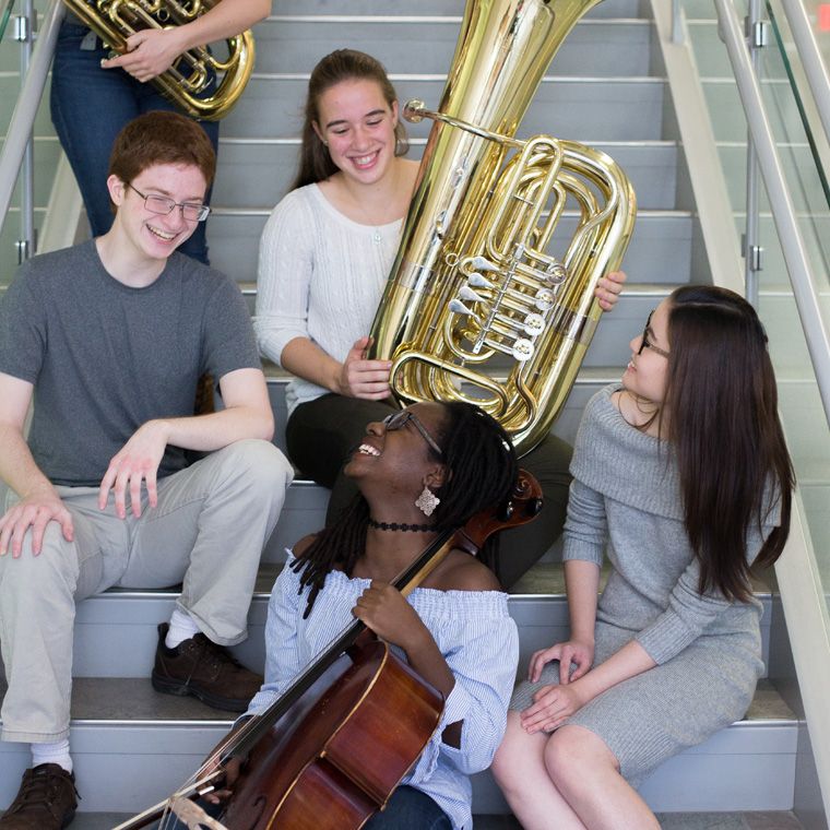 Four Wheaton College Conservatory Students with Instruments on Staircase