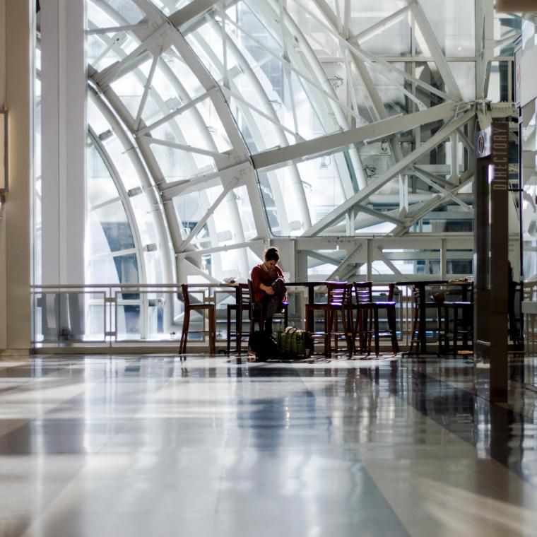 Woman sitting in open space inside a skyrise