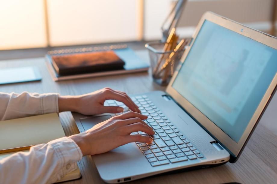 hands on a laptop