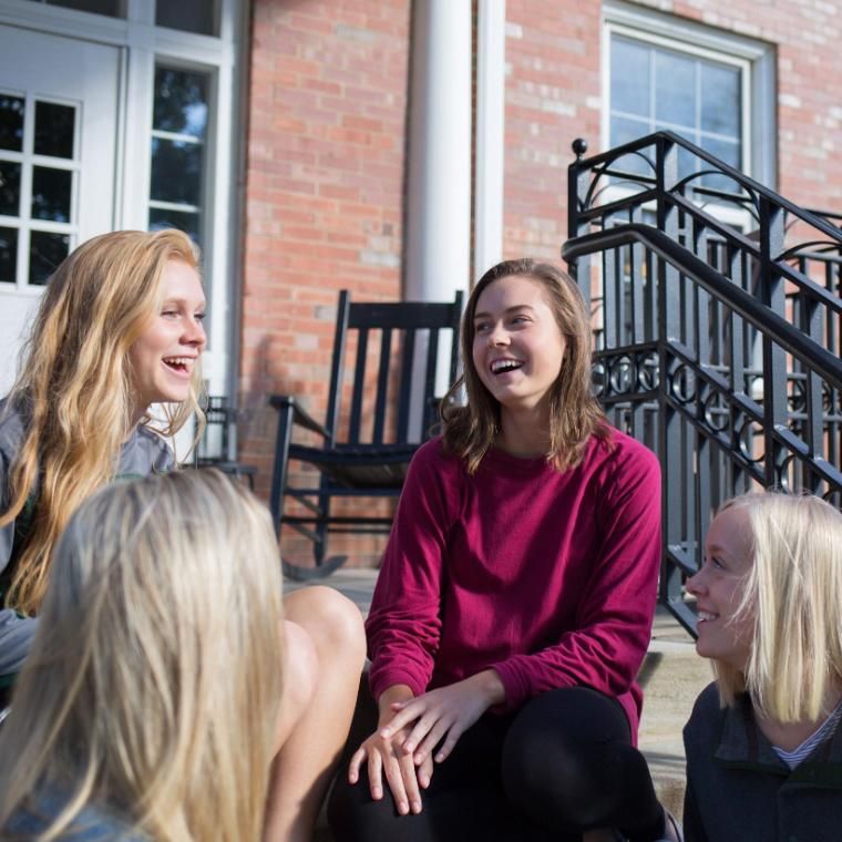 Wheaton College Graduate Resident Assistant with students on MacEvans Porch