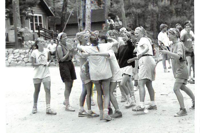 High road women celebrate under a welcome home banner at HoneyRock