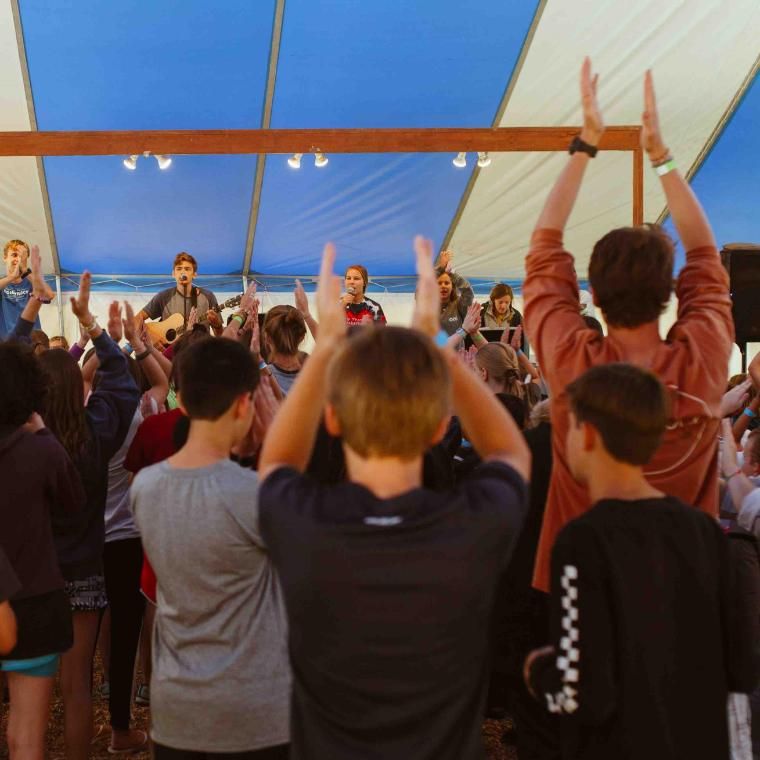 Before the first activity period, Res campers go to camper worship in the blue and white tent. This is often a highlight for campers as they sing and praise God through song.