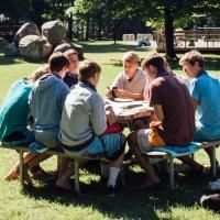 high schoolers talking at a table