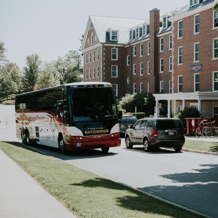 nationwide bus pulling around the corner at Wheaton College