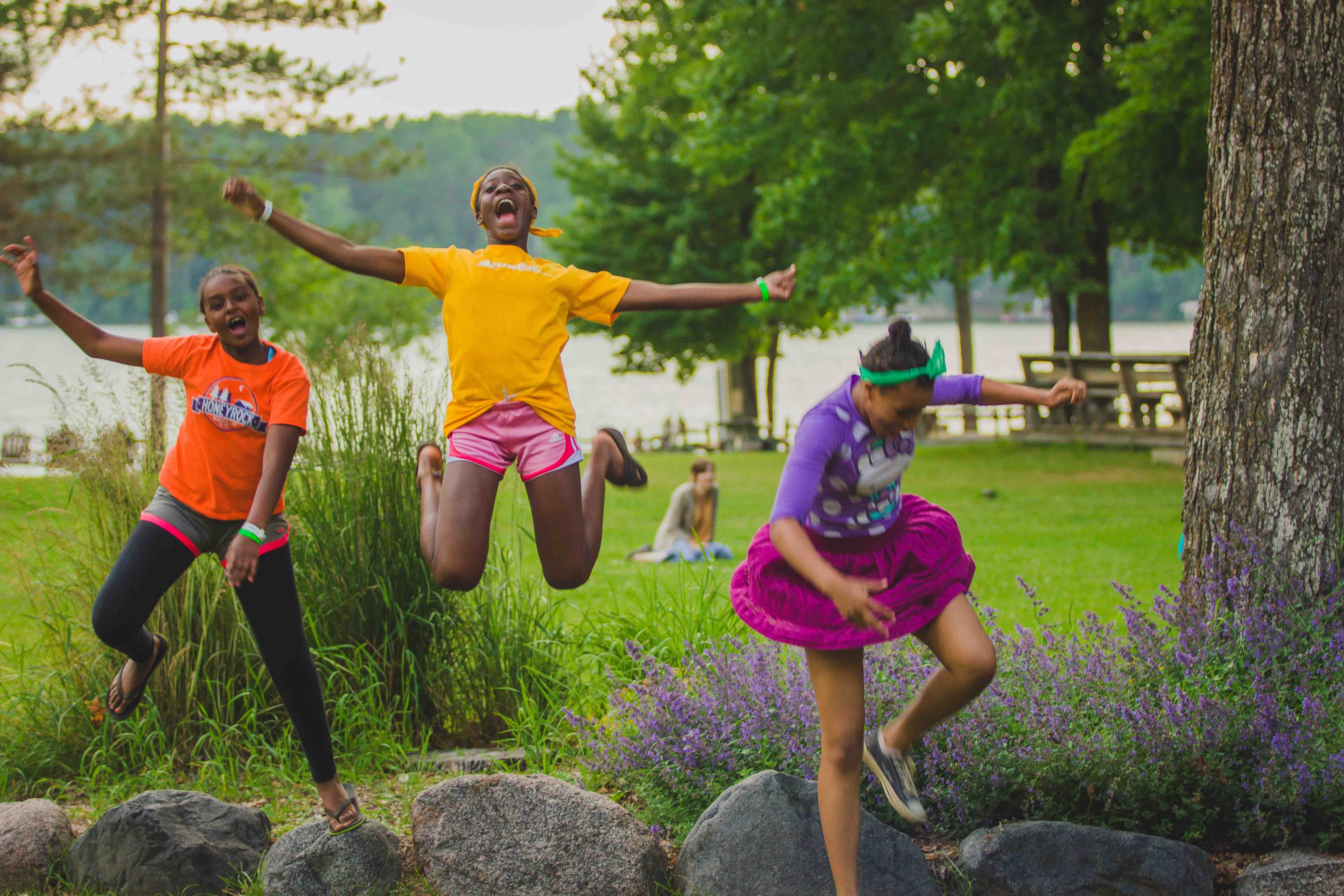 campers jumping off rocks at HoneyRock