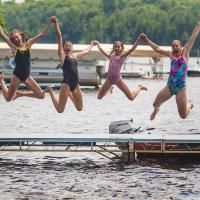 campers jump off dock at honeyrock