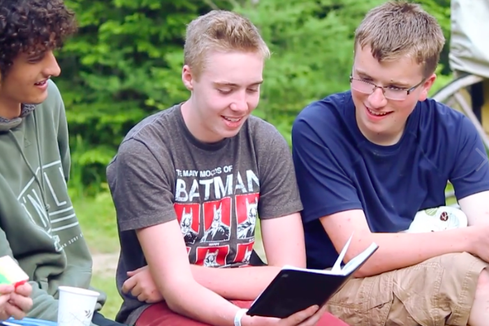 camper boys reading bible