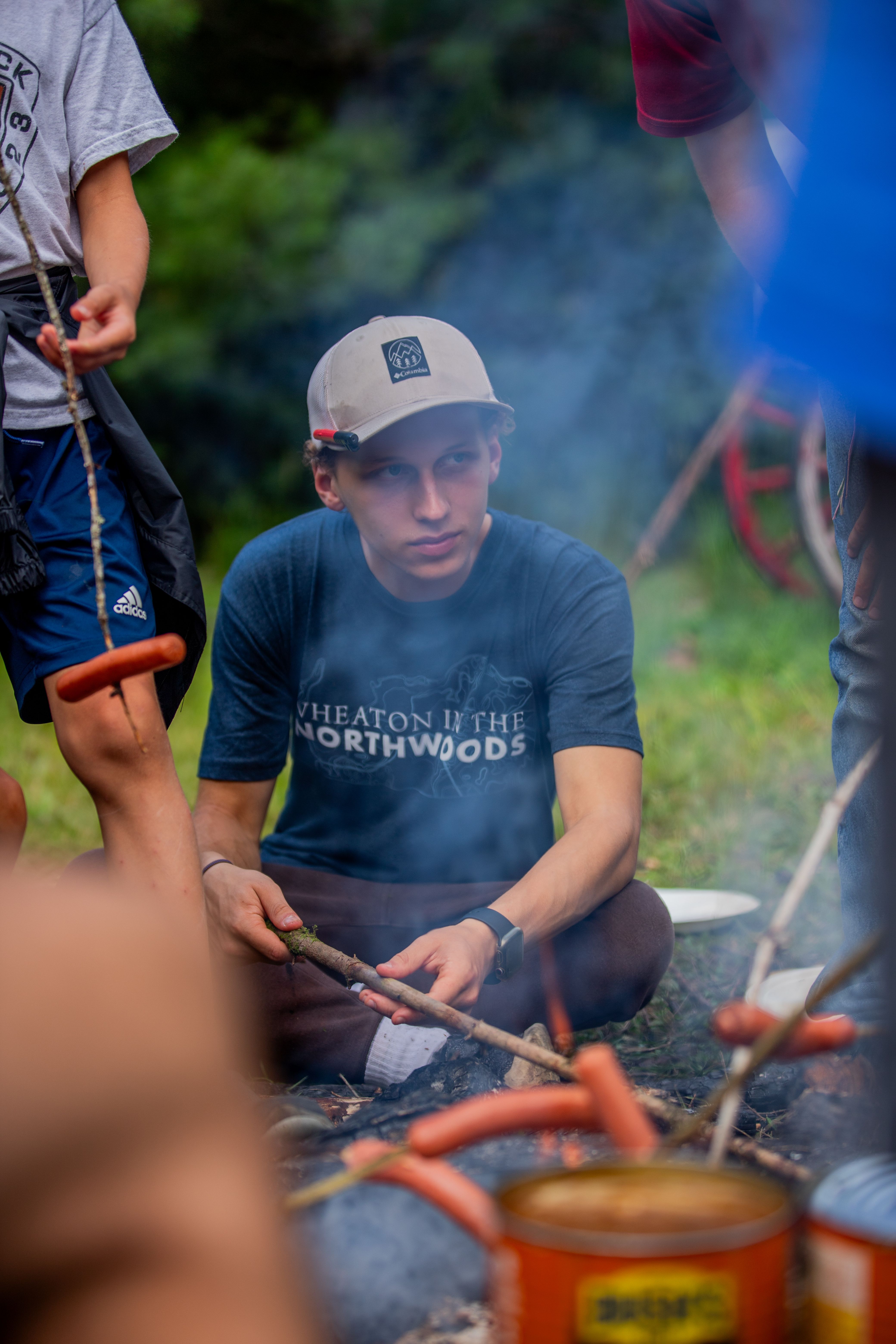 Wheaton student roasting a marshmallow at HoneyRock