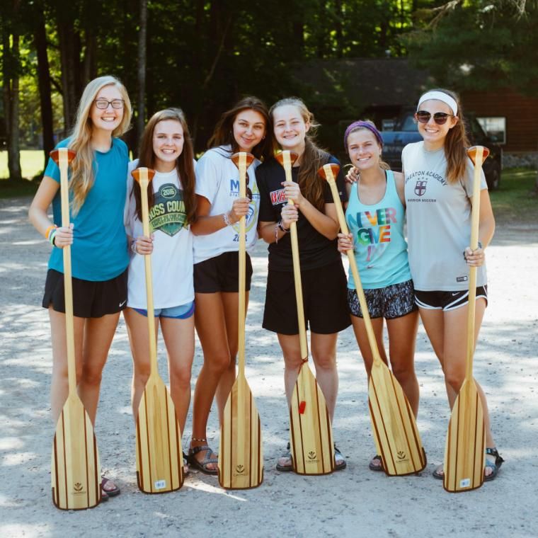 voyageur campers standing with paddles